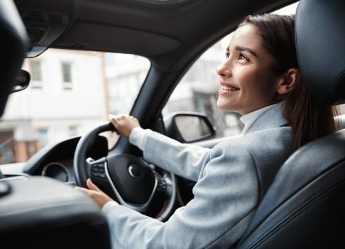 A woman is visibly happy in her salary sacrifice scheme car