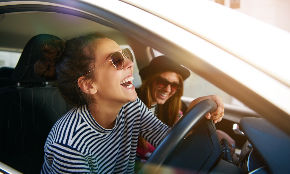 Two women drive on a road trip